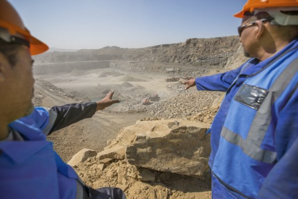 Workers in hard hats at a mining site